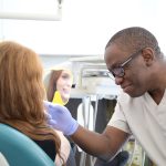 Botox for Facial Rejuvenation Specialists showing their female patient their Botox for Facial Rejuvenation Results who is happy and smiling looking in the mirror with her new Botox for Facial Rejuvenation