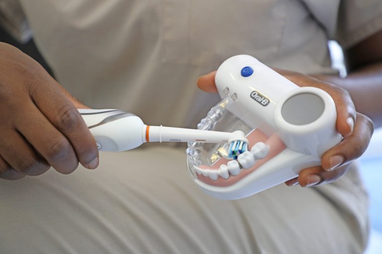 Oral Cancer Screening and Treatment Specialists showing their patient their Oral Cancer Screening and Treatment Post Care Methods