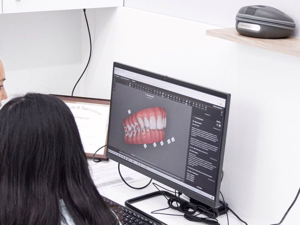A patient viewing a 3D aligner scan with a clinician