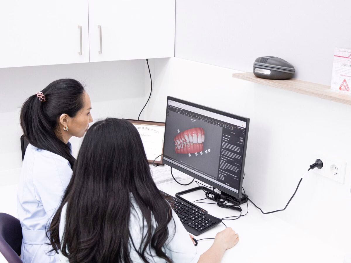 A patient viewing a 3D aligner scan with a clinician