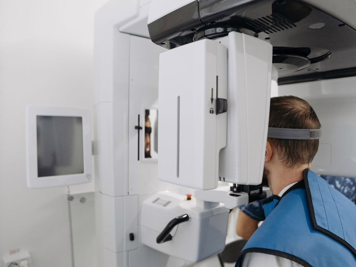 A patient positioned at a CBCT scanner