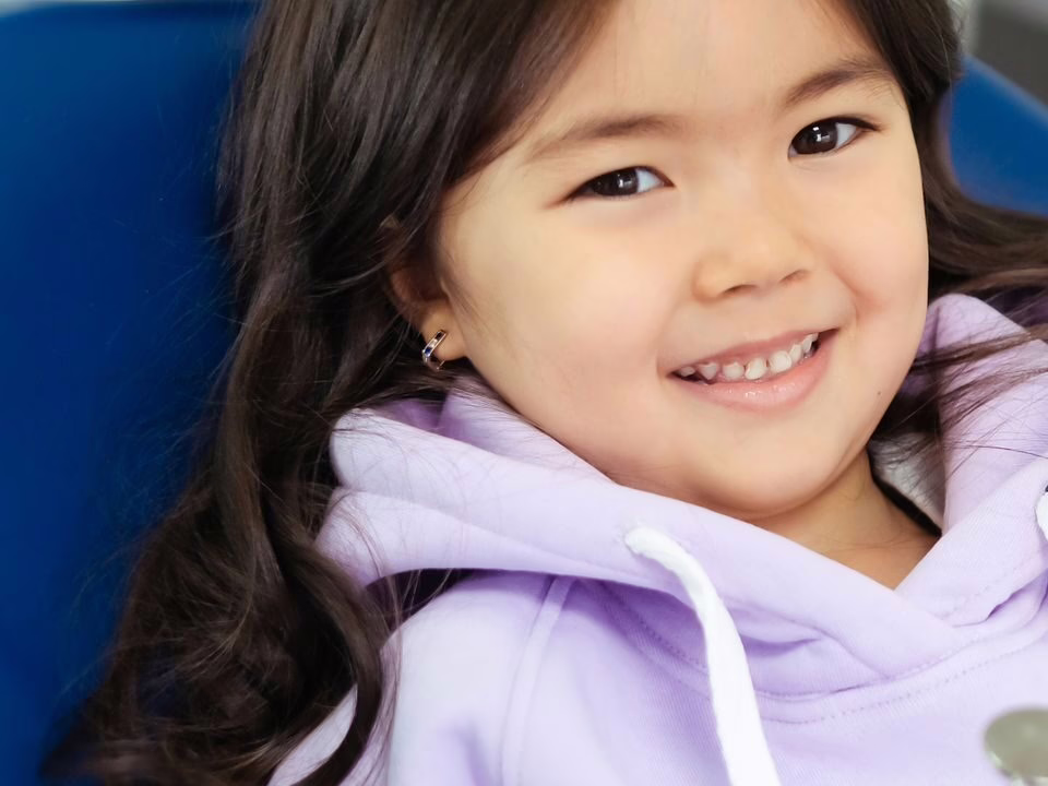 A smiling girl in the dental chair
