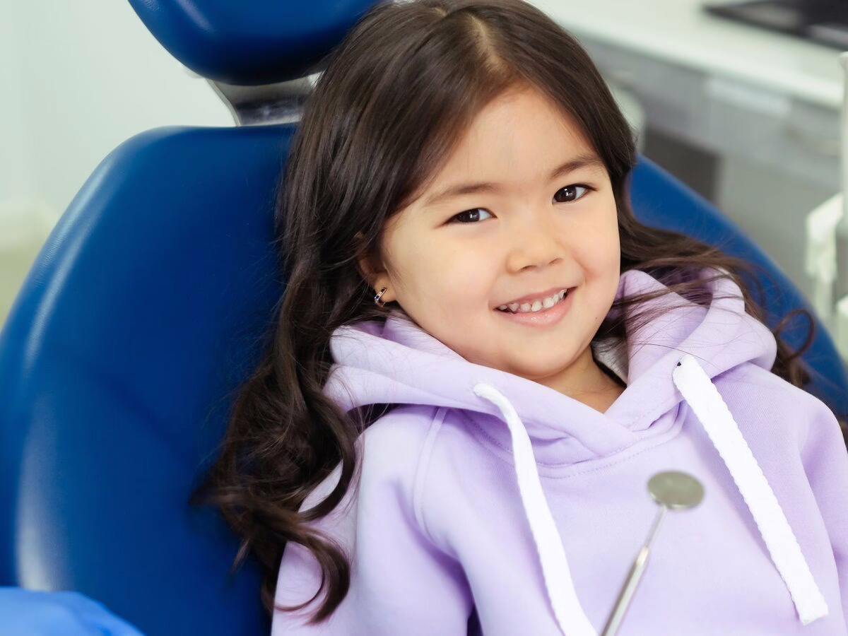 A smiling girl in the dental chair