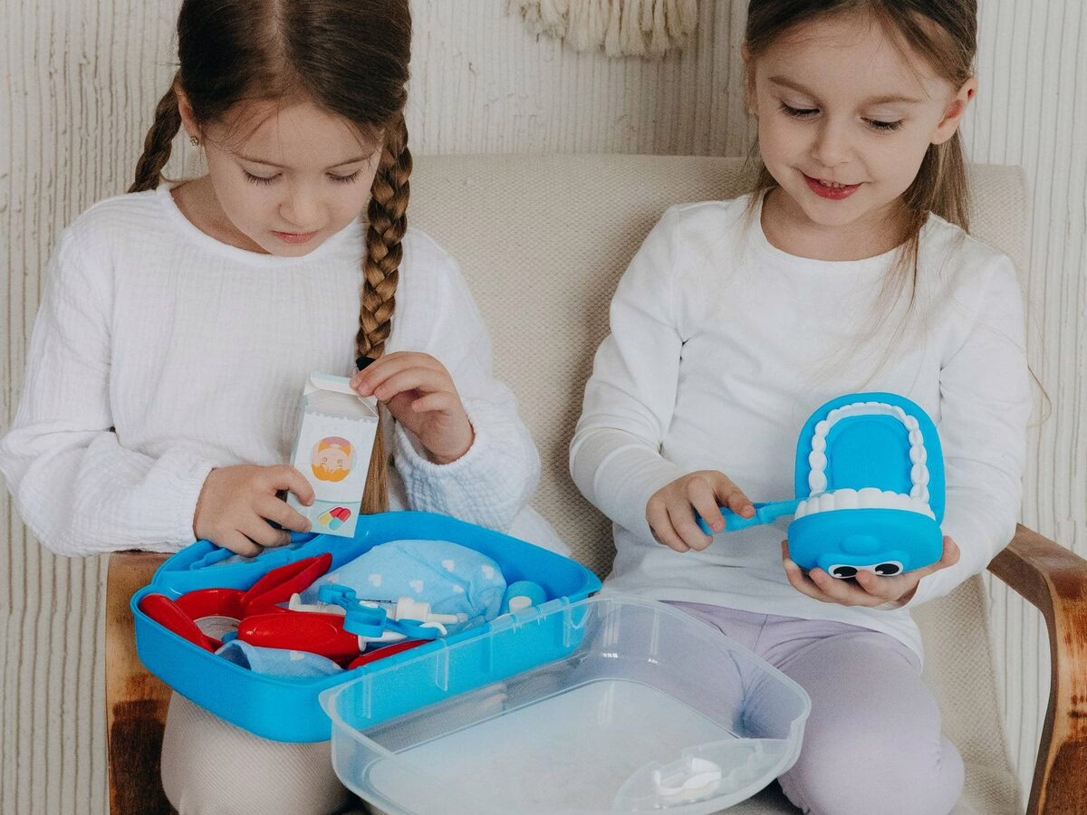 Children playing with a toy dentist kit