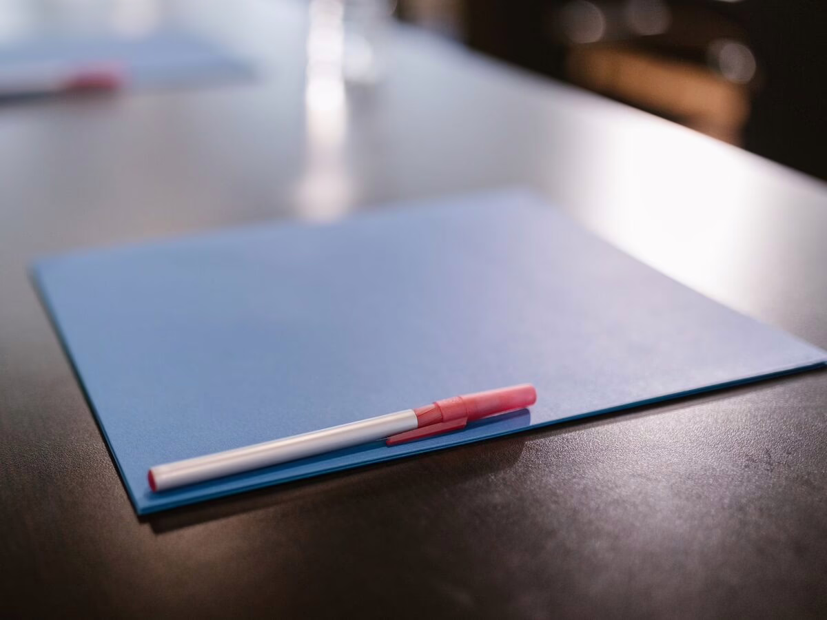 A folder and pen ready for a treatment plan discussion