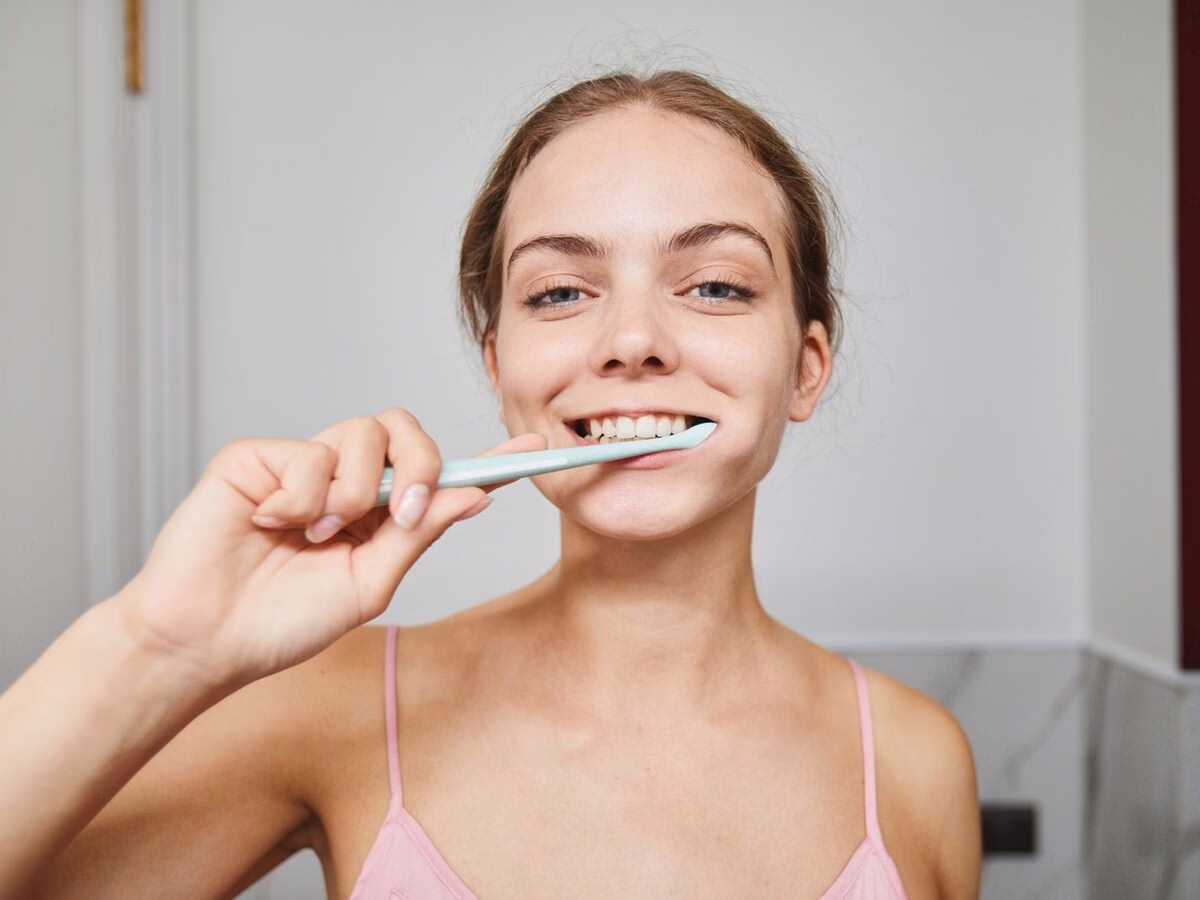 A woman brushing her teeth
