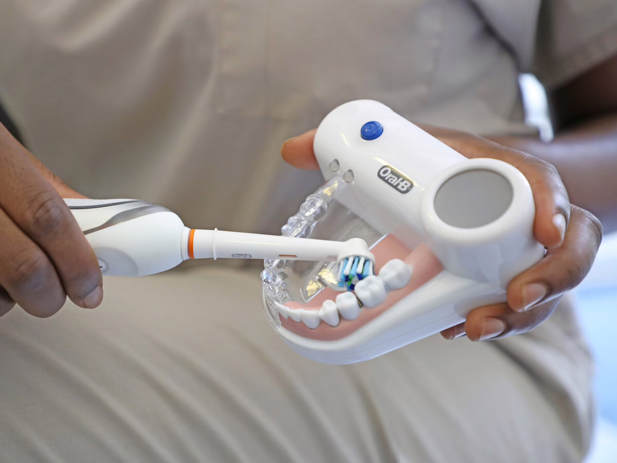 Electric toothbrush technique demonstrated on a dental model