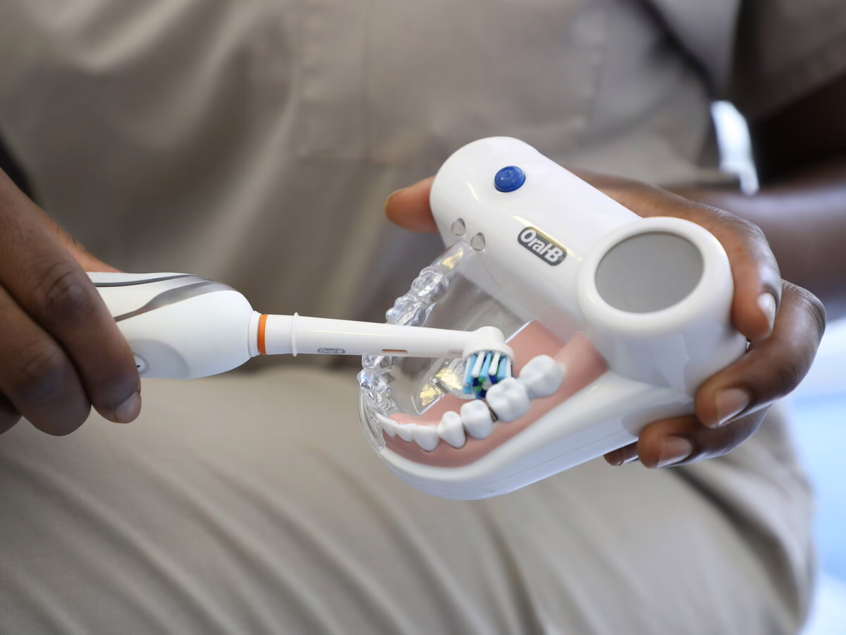 Electric toothbrush technique demonstrated on a dental model