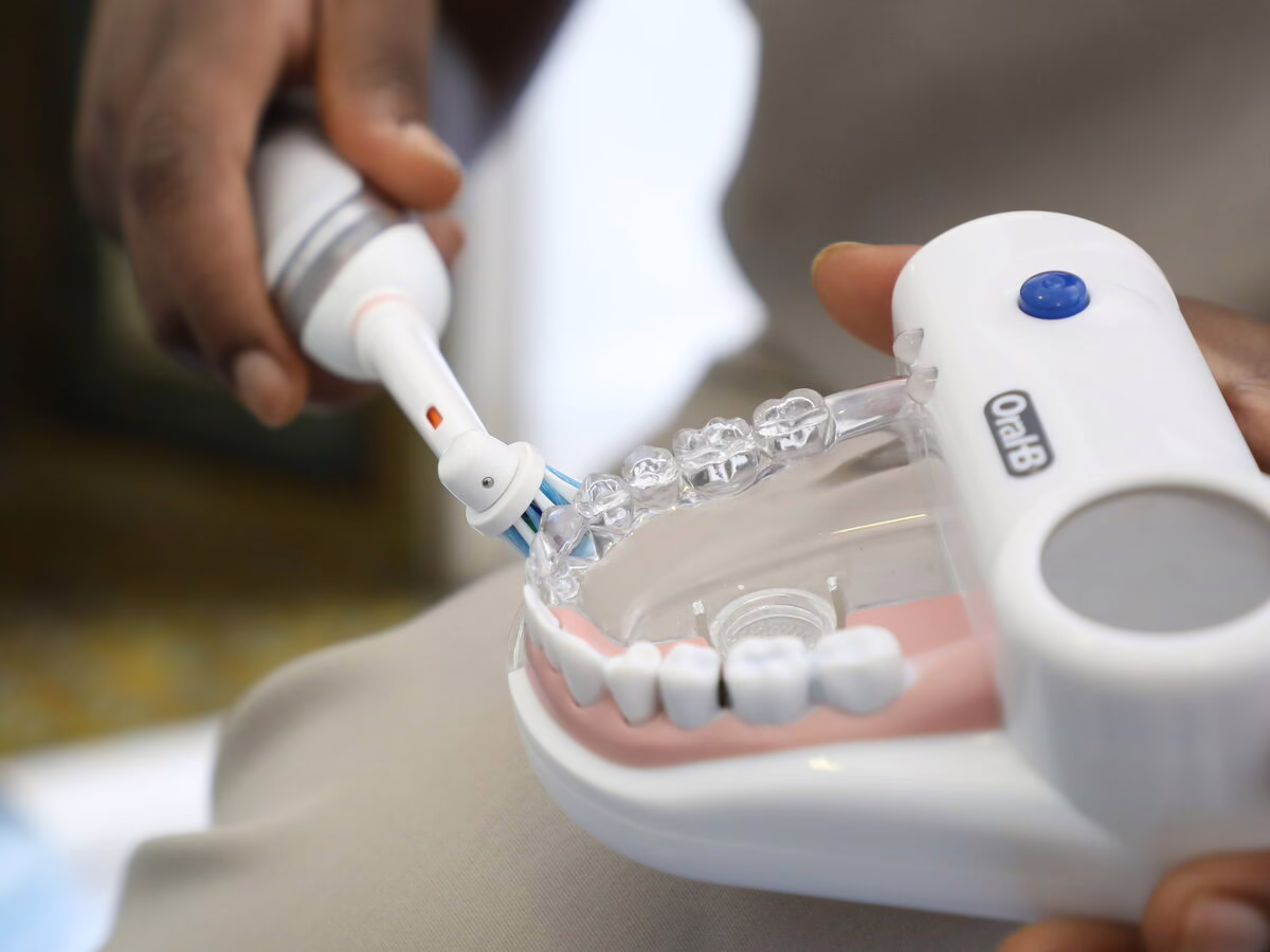 Electric toothbrush technique demonstrated on a dental model