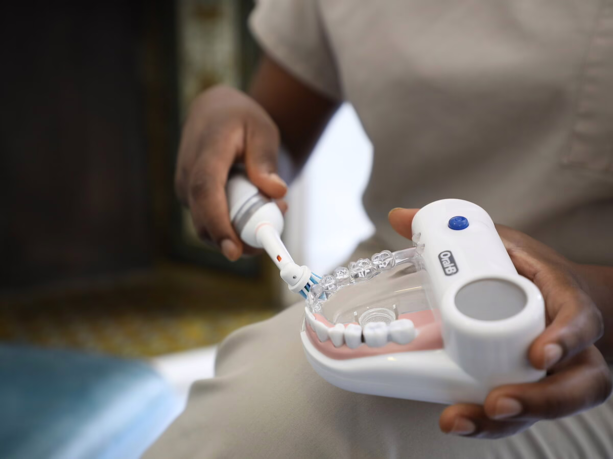 Electric toothbrush technique demonstrated on a dental model