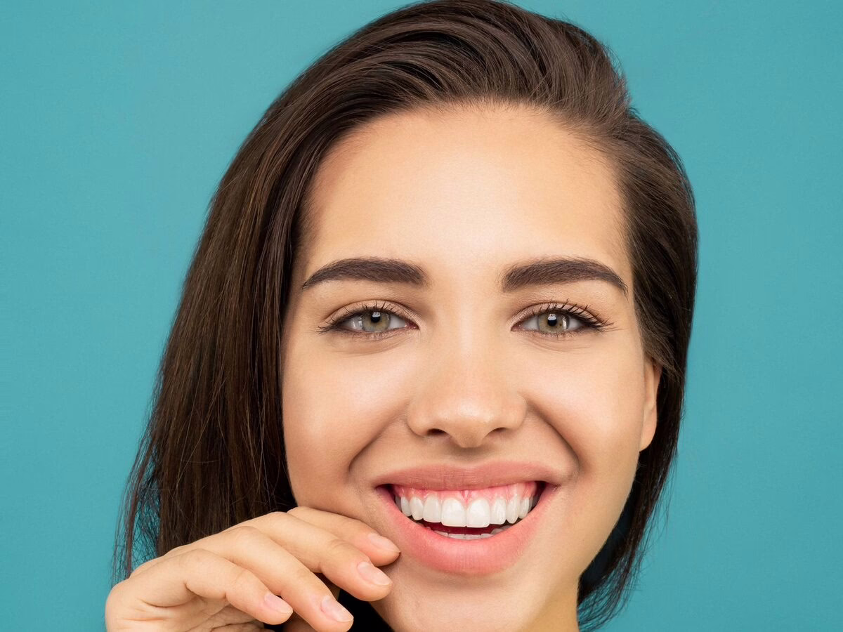 A woman fitting her clear aligner
