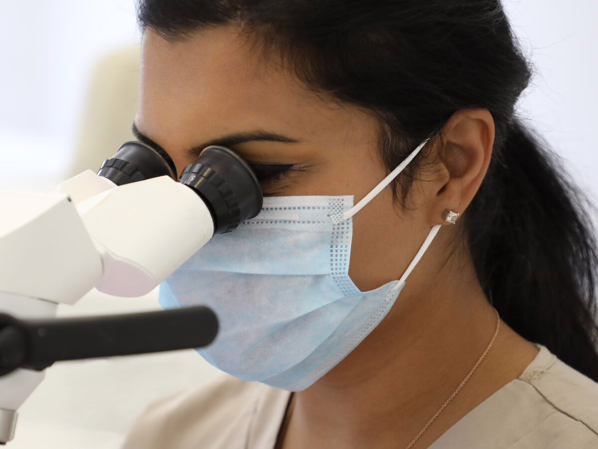 Dr Neha Patel, specialist endodontist, at the endodontic microscope