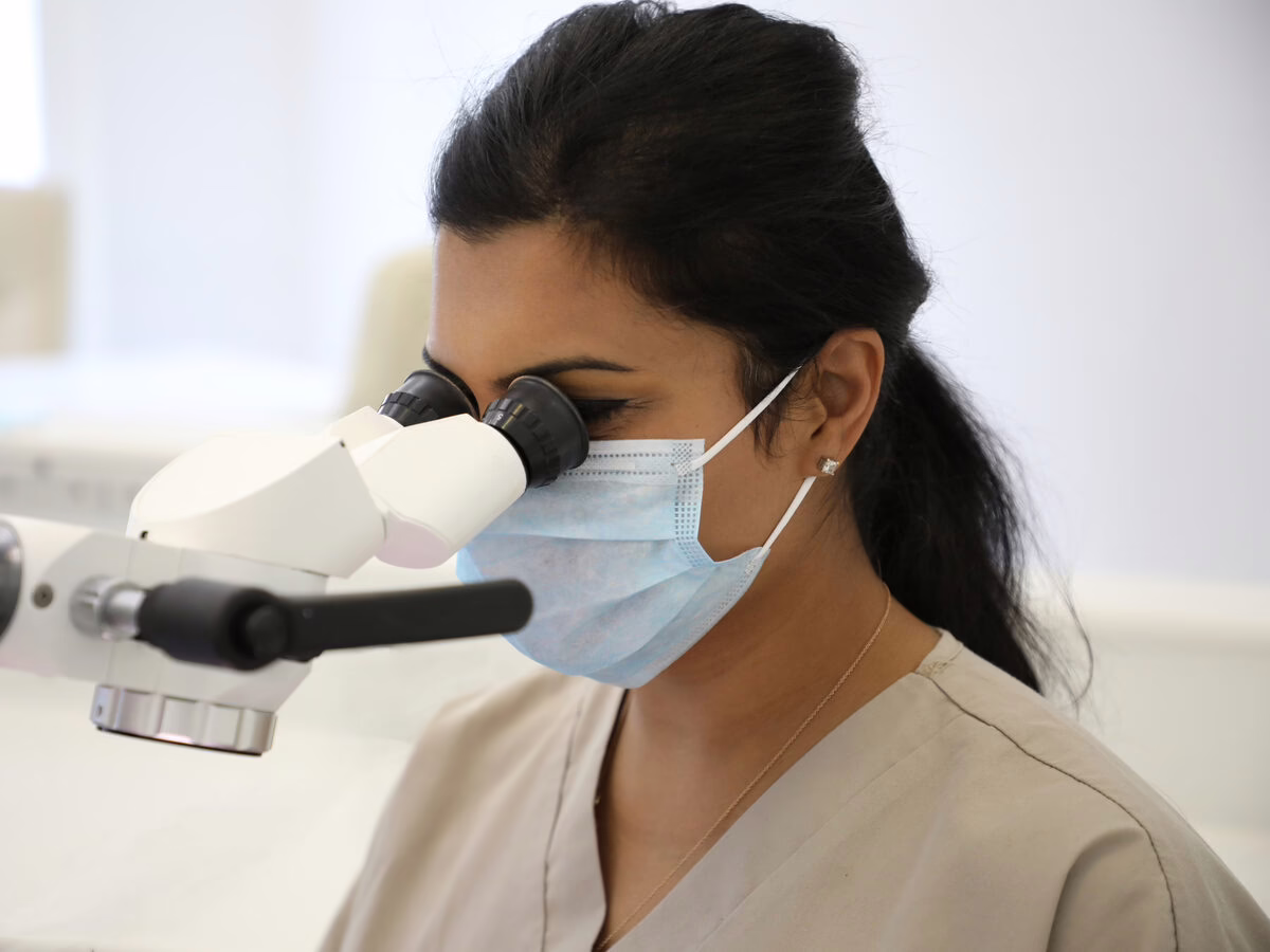 Dr Neha Patel, specialist endodontist, at the endodontic microscope