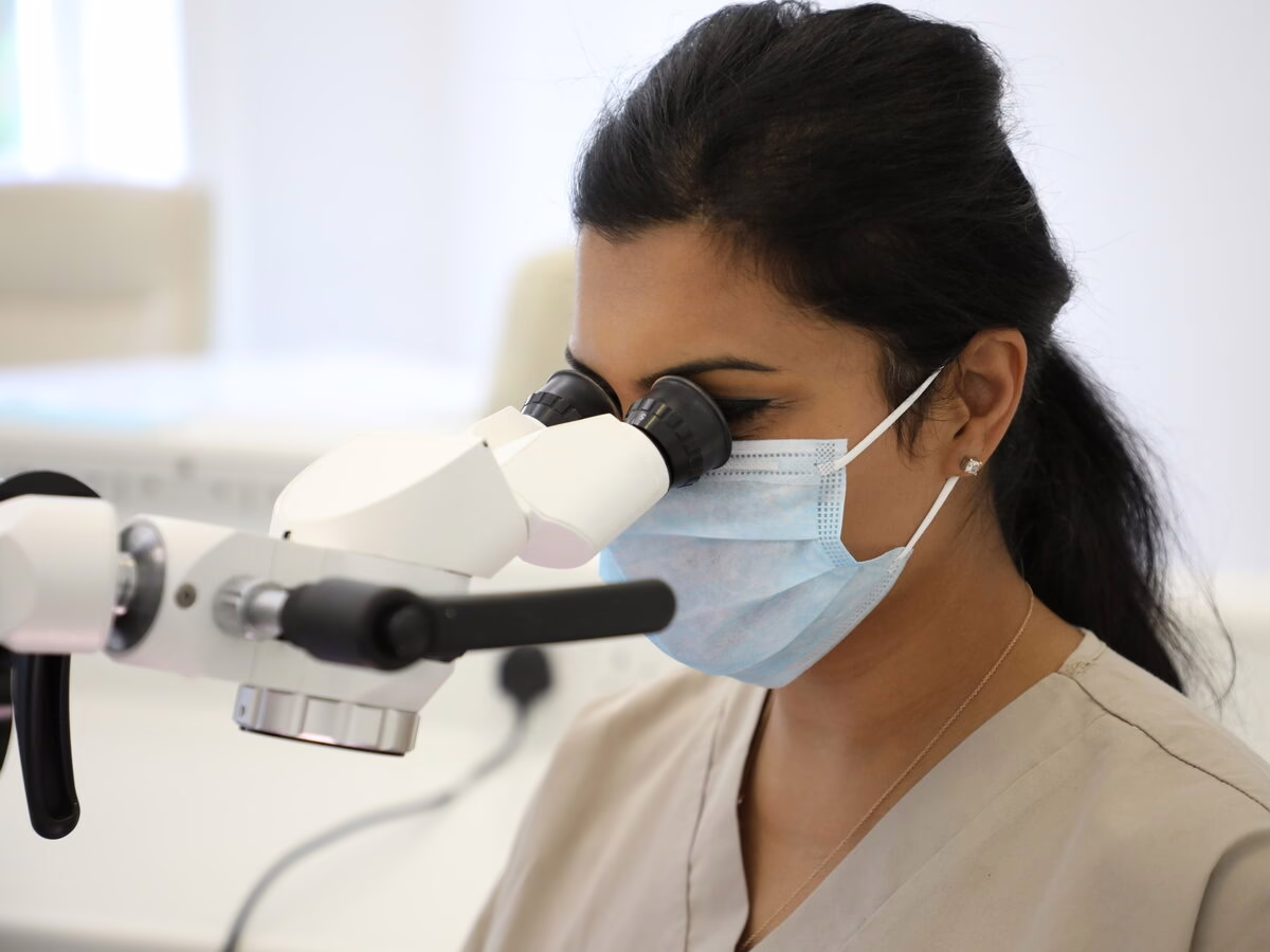 Dr Neha Patel, specialist endodontist, at the endodontic microscope