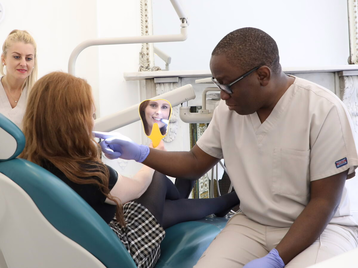 Dr Ope Sodeinde and the dental therapist with a patient