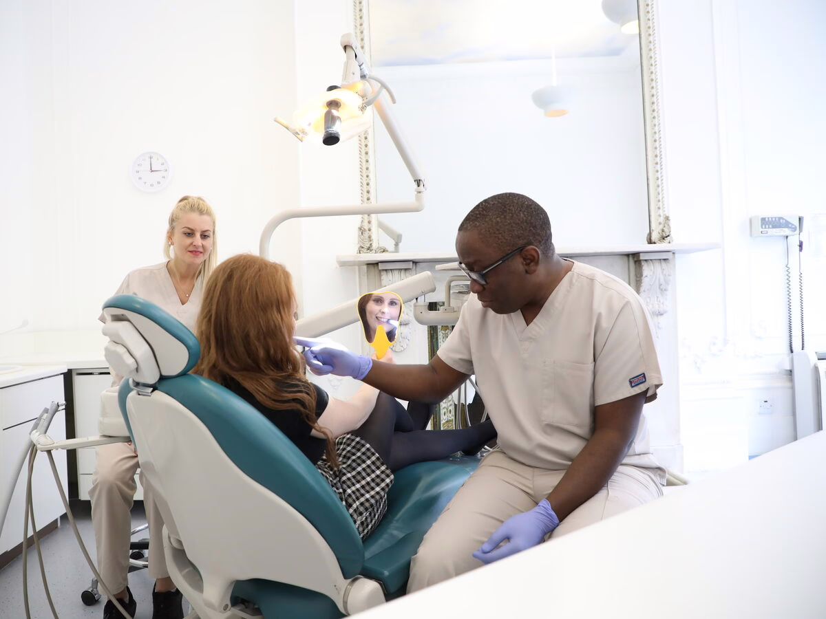Dr Ope Sodeinde and the dental therapist with a patient