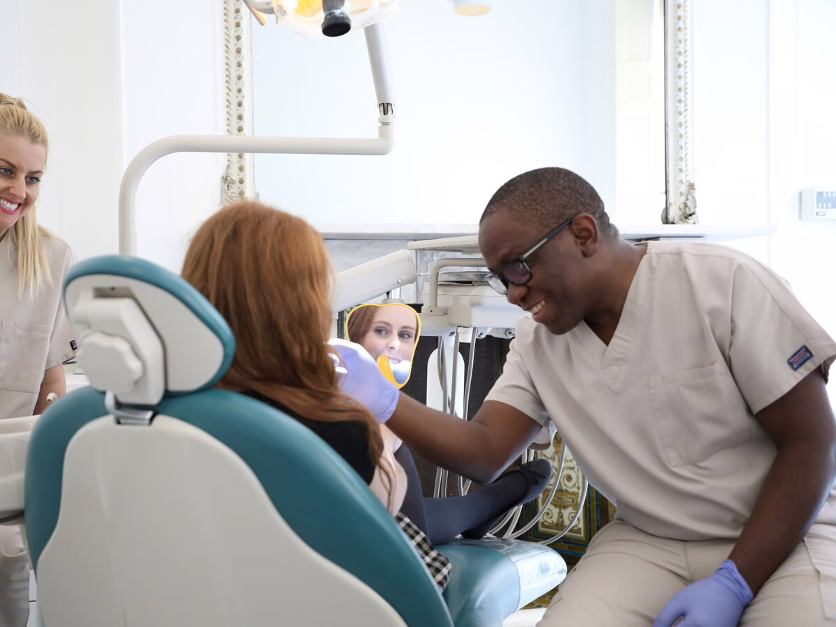 Dr Ope Sodeinde and the dental therapist with a patient