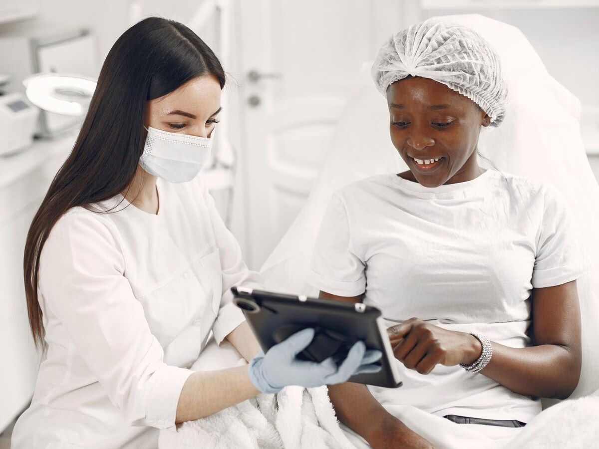 A clinician showing a patient information on a tablet