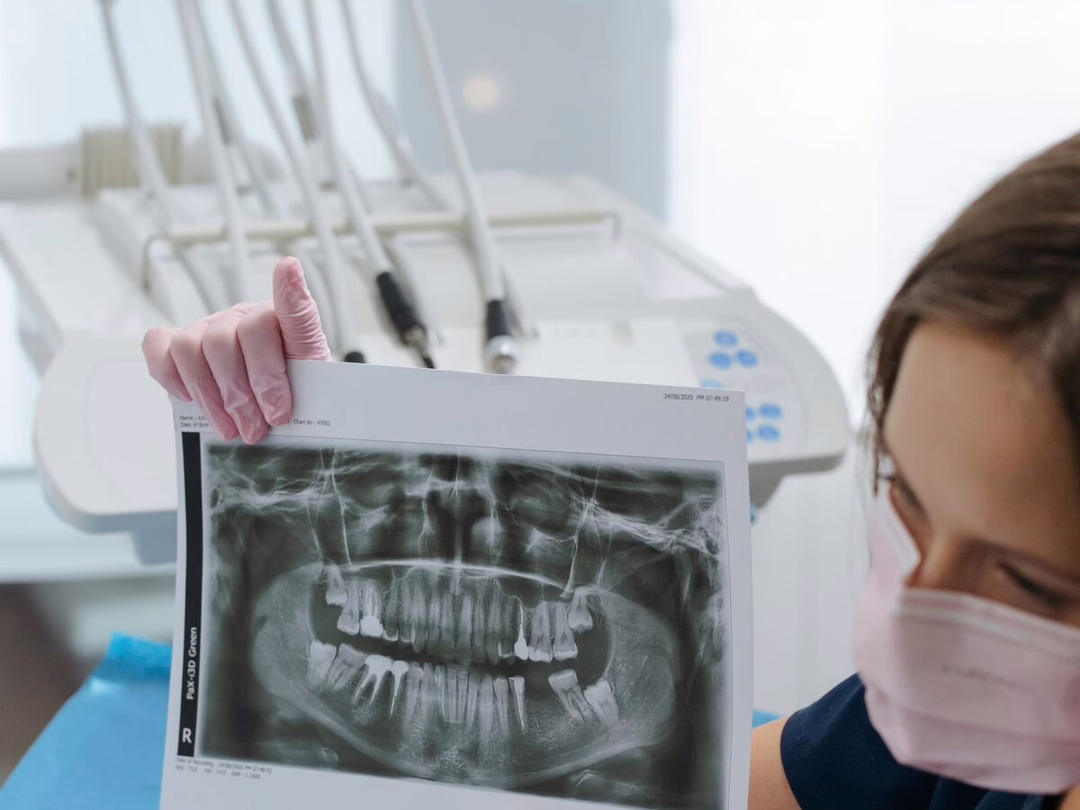 A dentist showing a panoramic x-ray to a patient